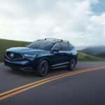 Acura MDX driving down curvy road