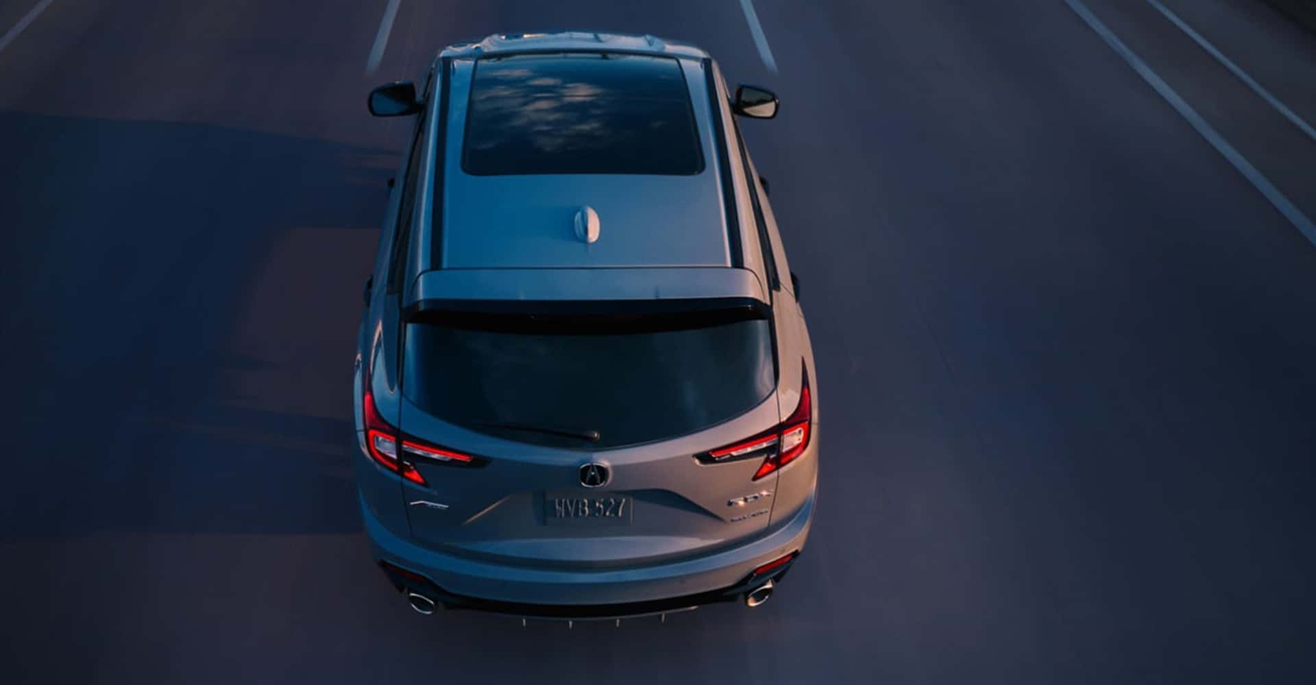 2026 Acura RDX driving during sunset