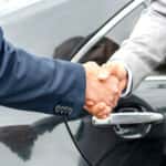 Business handshake near car photo