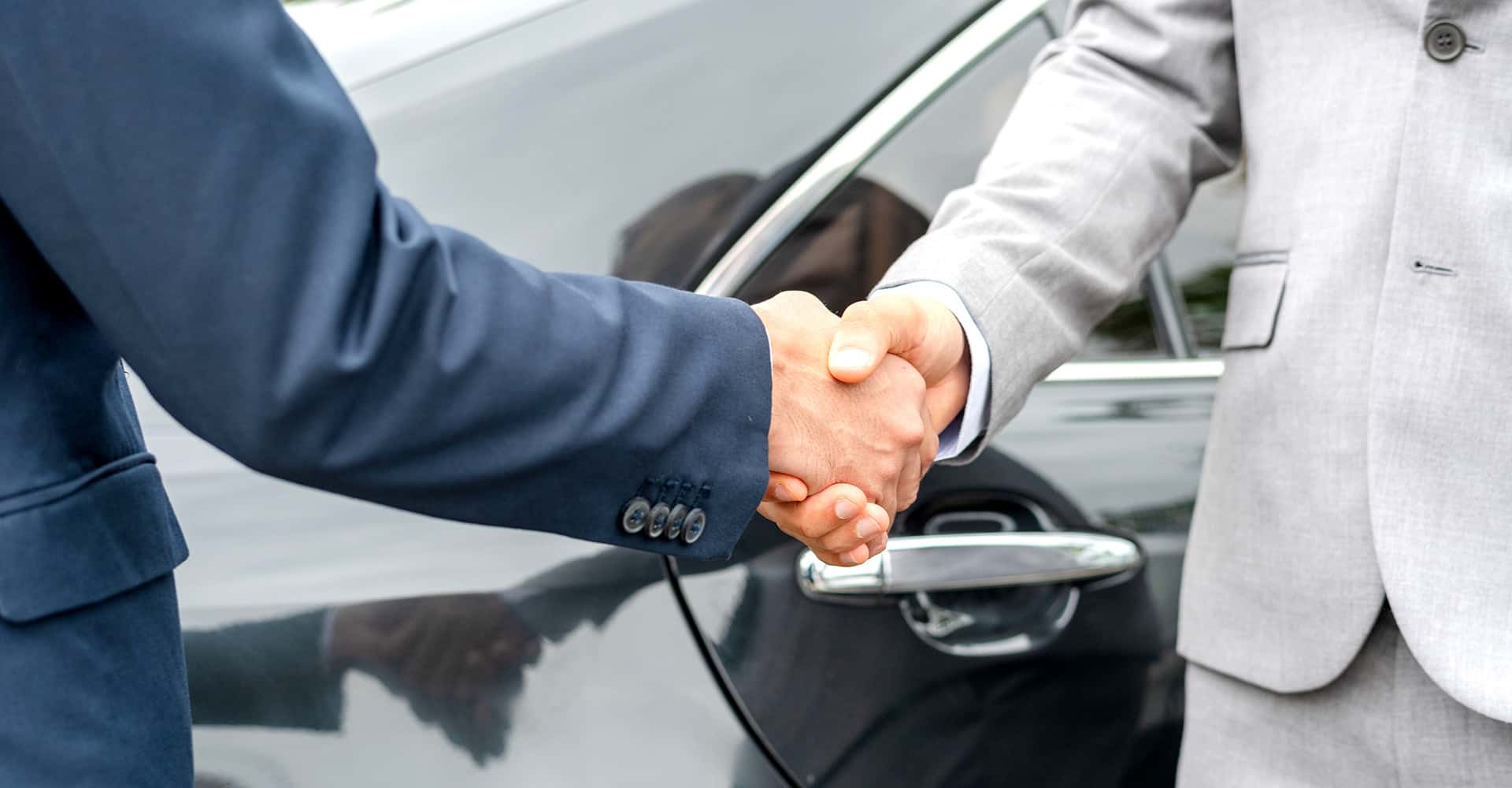 Business handshake near car photo