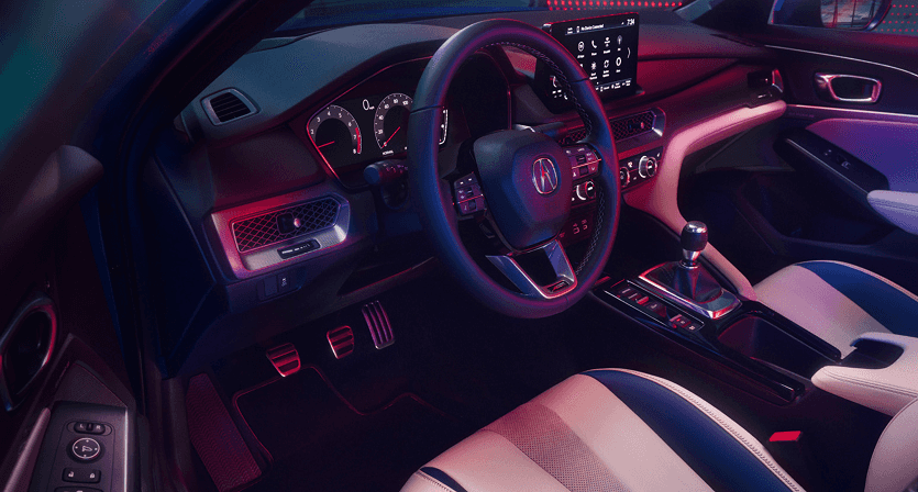 2026 Acura Integra A-Spec interior with red ambient lighting and sport pedals