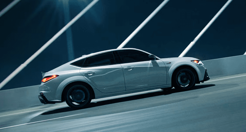 2026 Acura Integra Type S side profile driving across a bridge
