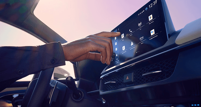 Driver interacting with 2026 Acura ADX center touchscreen infotainment display