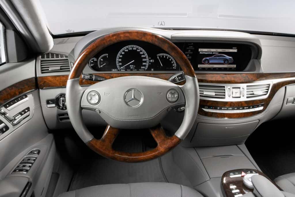 Mercedes Steering Wheel and Gauge Cluster, Infotainment Center in Gray with Wood Accents