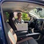 A Business Woman Working Inside Her Mobile Workspace, Typing On Her Computer