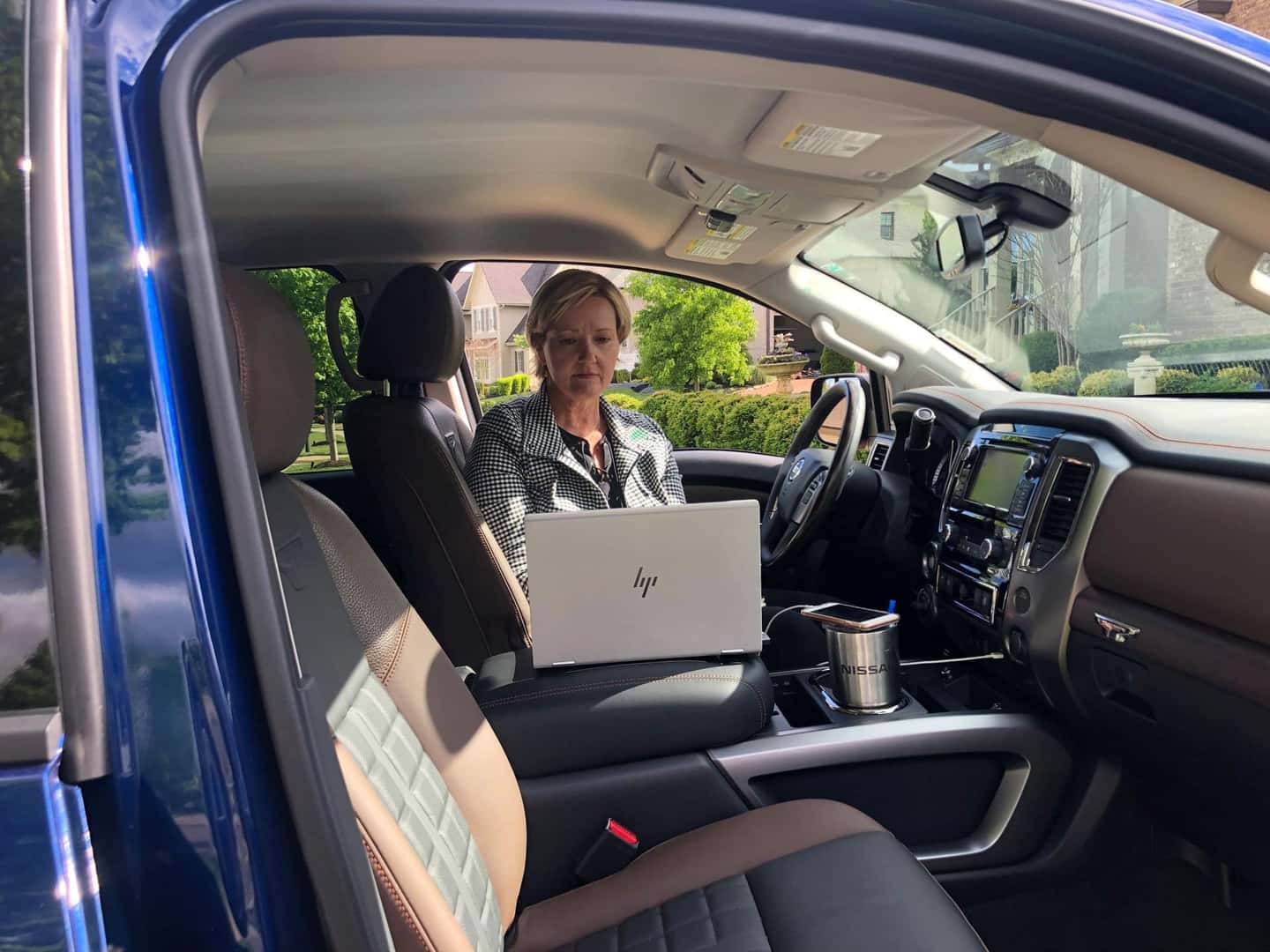 A Business Woman Working Inside Her Mobile Workspace, Typing On Her Computer