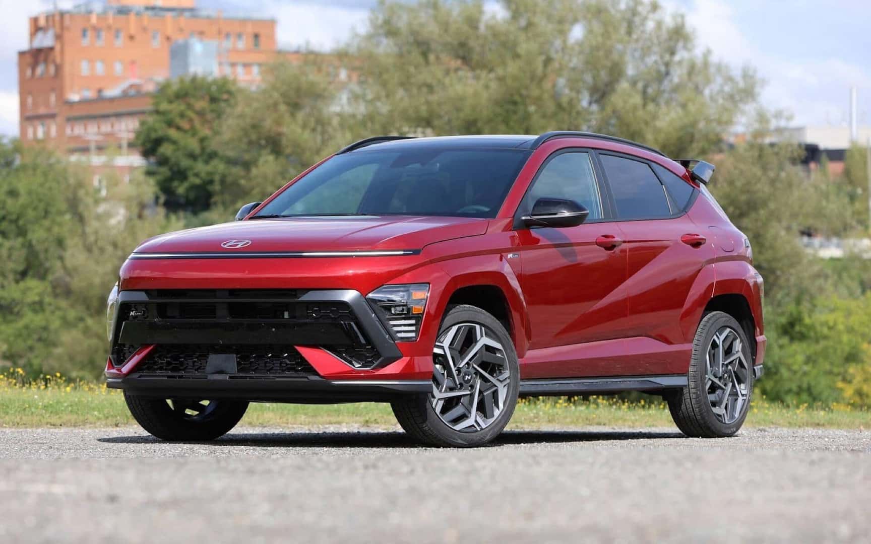 The Safe And Technologically Equipped 2024 Hyundai Kona, Parked Near Greenery In A Small City