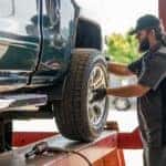 A Technician Rotating The Tires Of A Vehicle Efficiently And Effectively