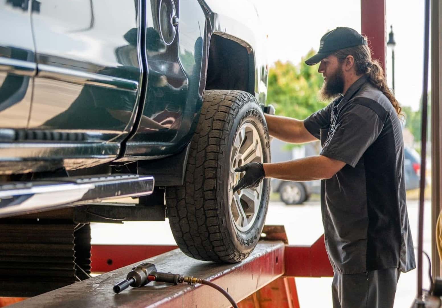 A Technician Rotating The Tires Of A Vehicle Efficiently And Effectively