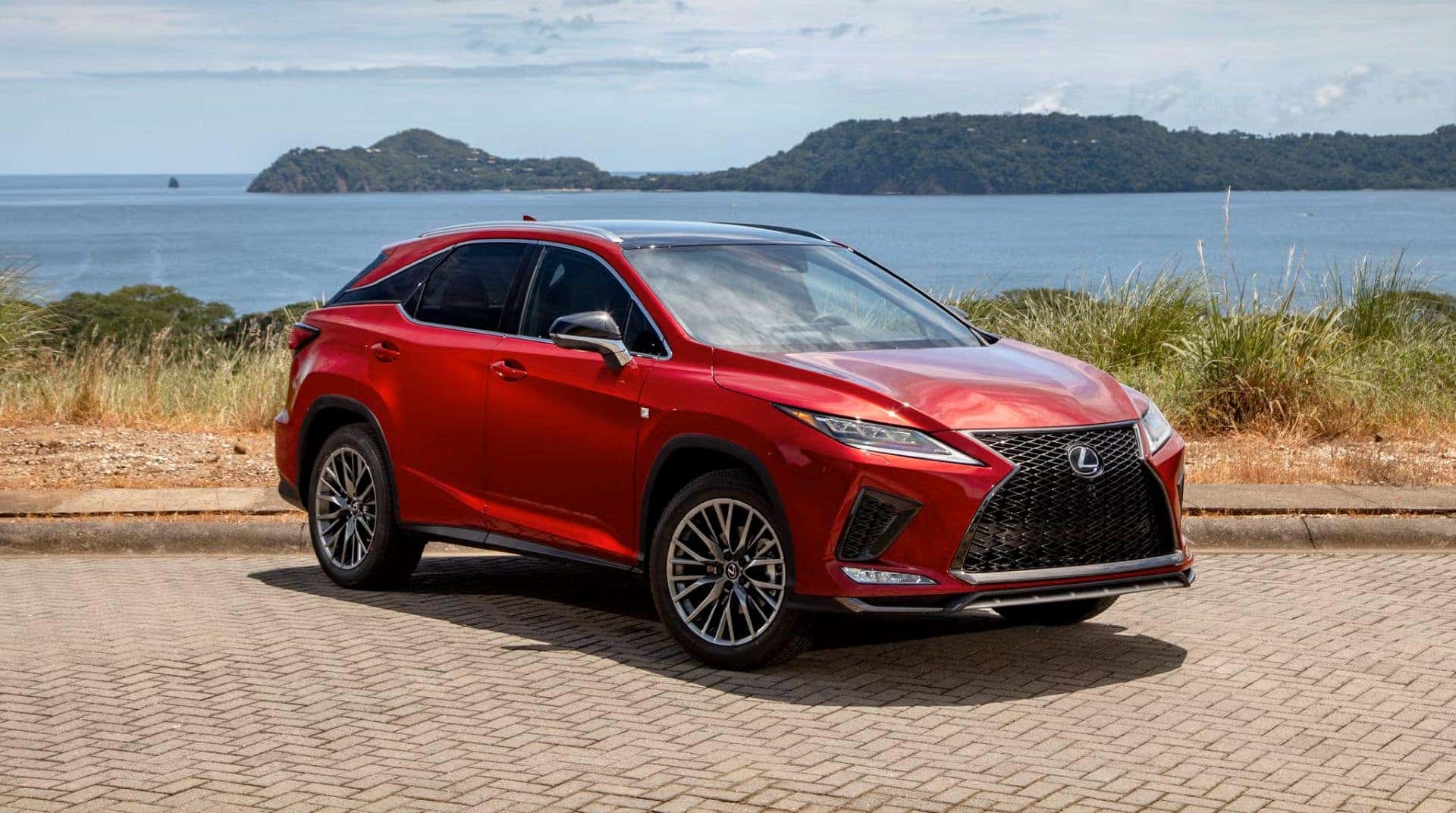 A Sexy Red 2020 Lexus RX, Parked On A Gorgeously Patterned Concrete Path, With A Gorgeous Lake And Vast Mountains In The Picturesque Background