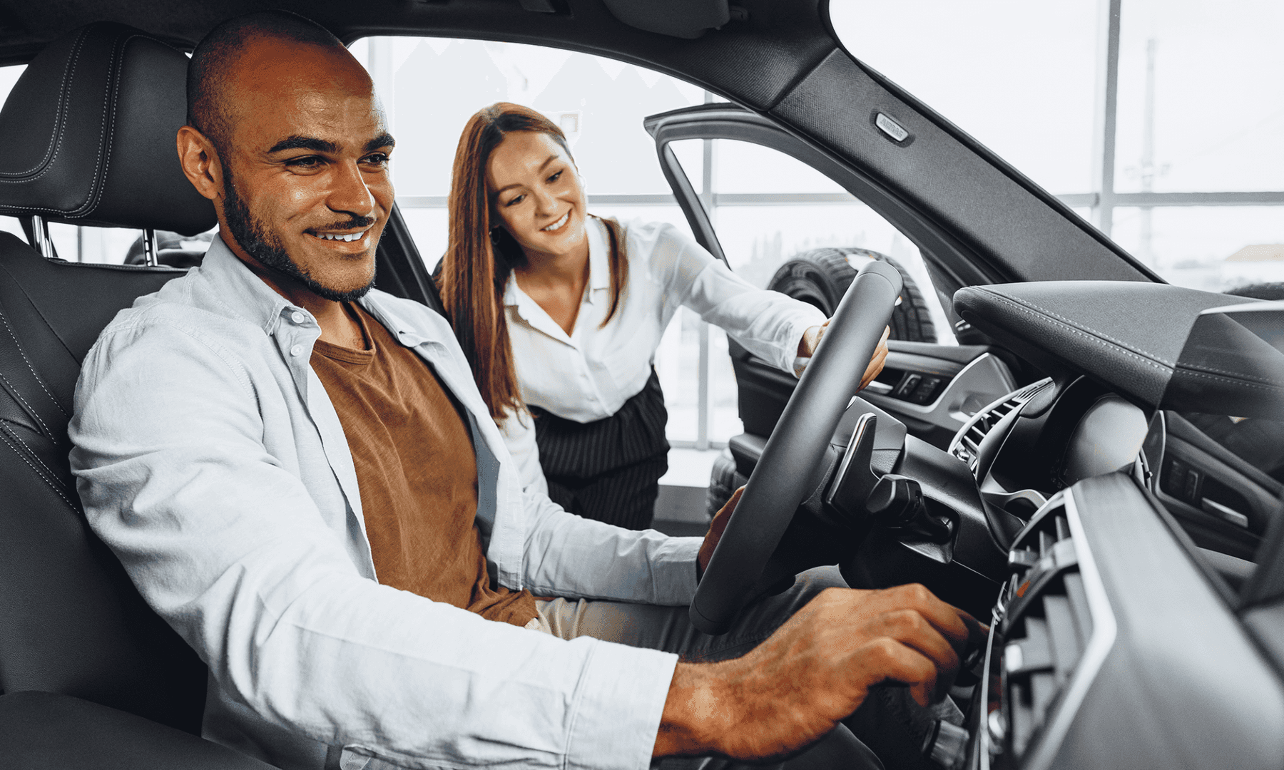 A Customer In The Driver's Seat, Helped By A Dealership Employee, Taking The Car On A Test Drive