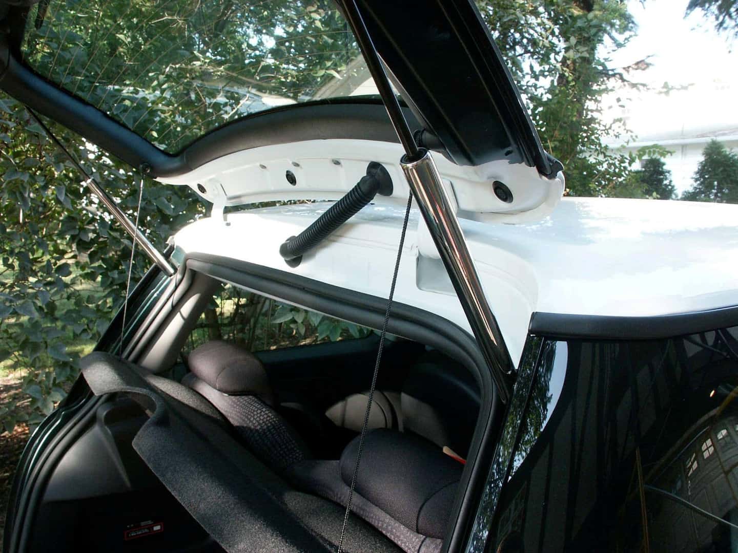 The Open Mini Hatch Struts, In The Rear Of The Vehicle