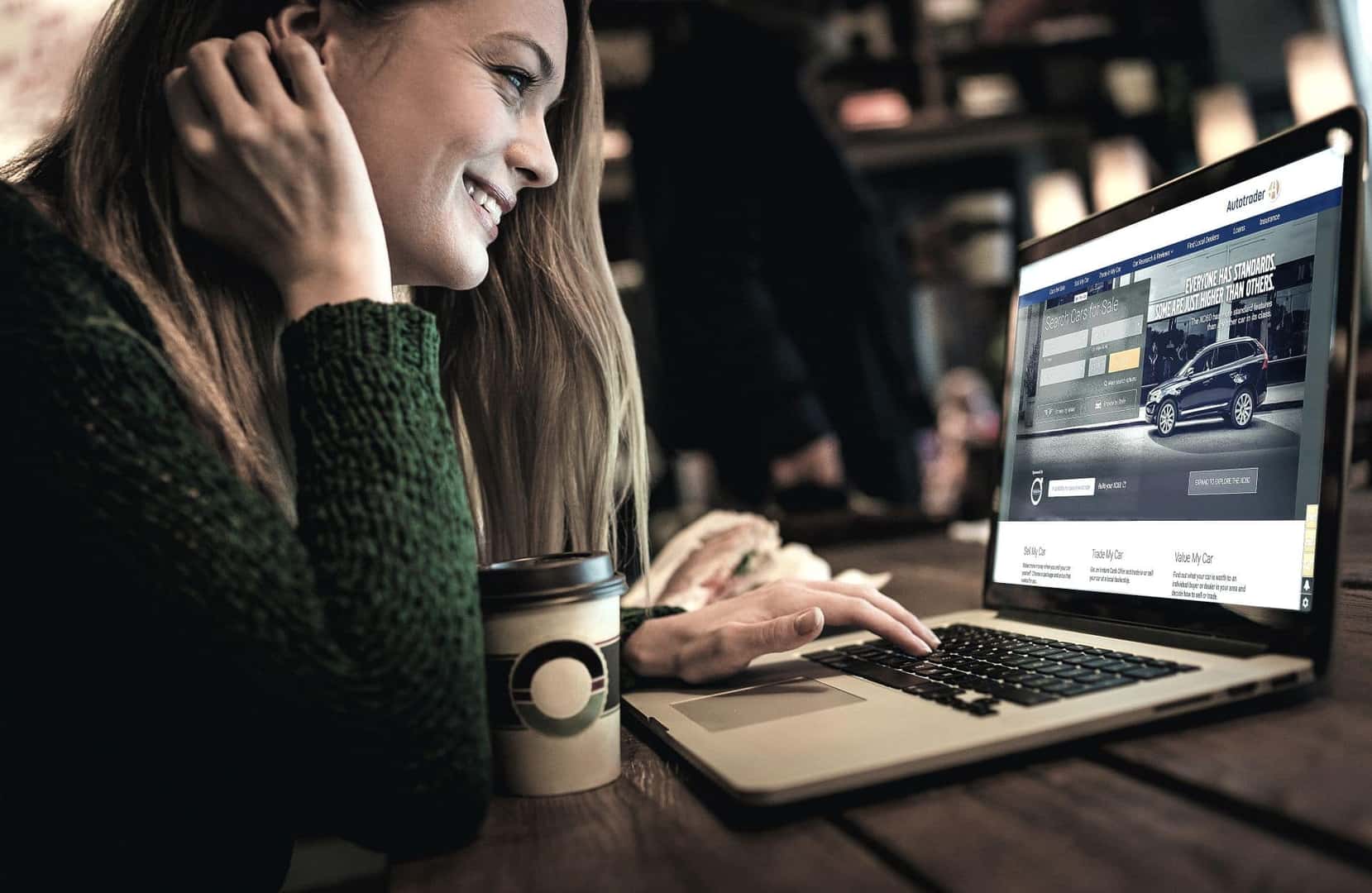 A Potential Customer Researching On Her Laptop About Used Cars