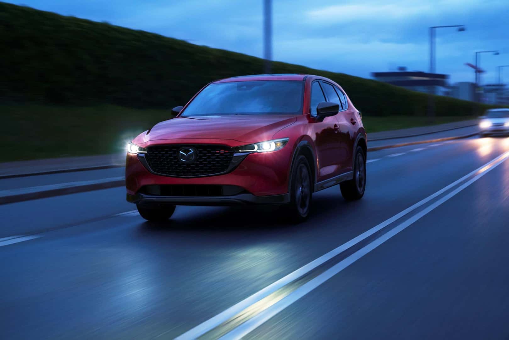 2022 Mazda CX-5 Turbo red driving with headlights on 
