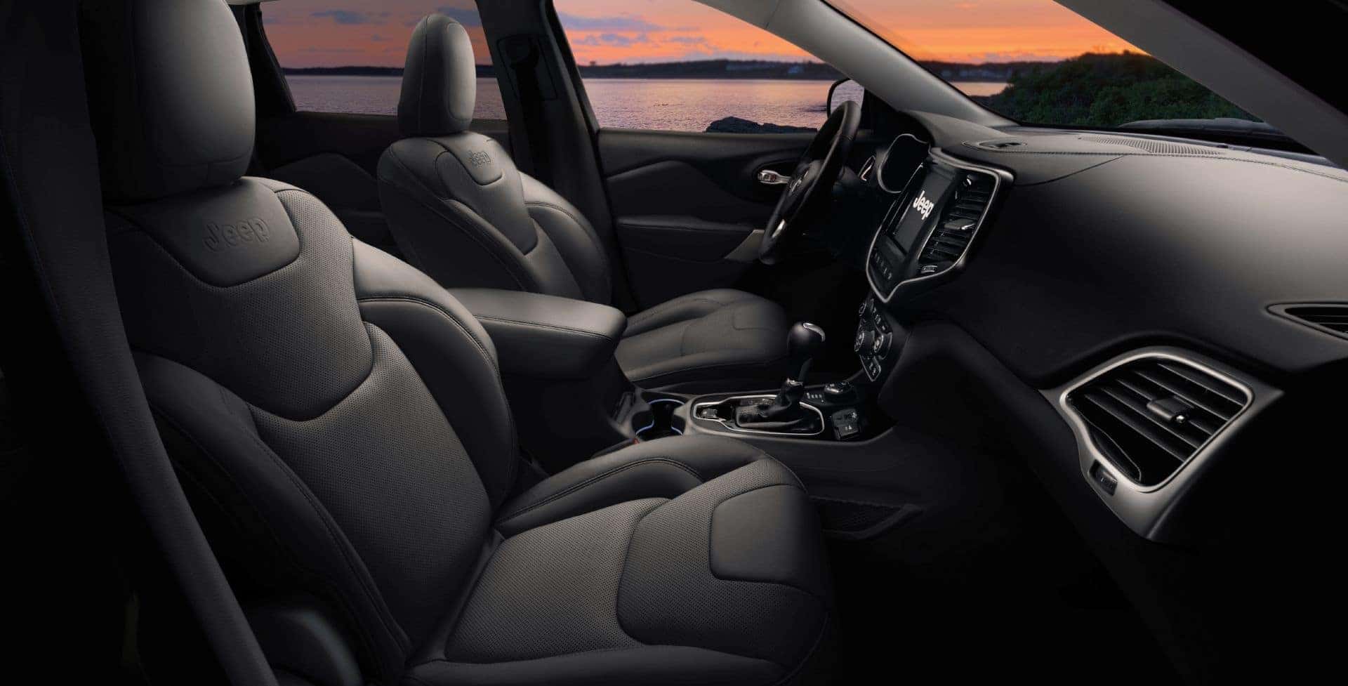 The Comfortable Black Seats And Wonderful Smelling Vents Of A Jeep's Front Interior