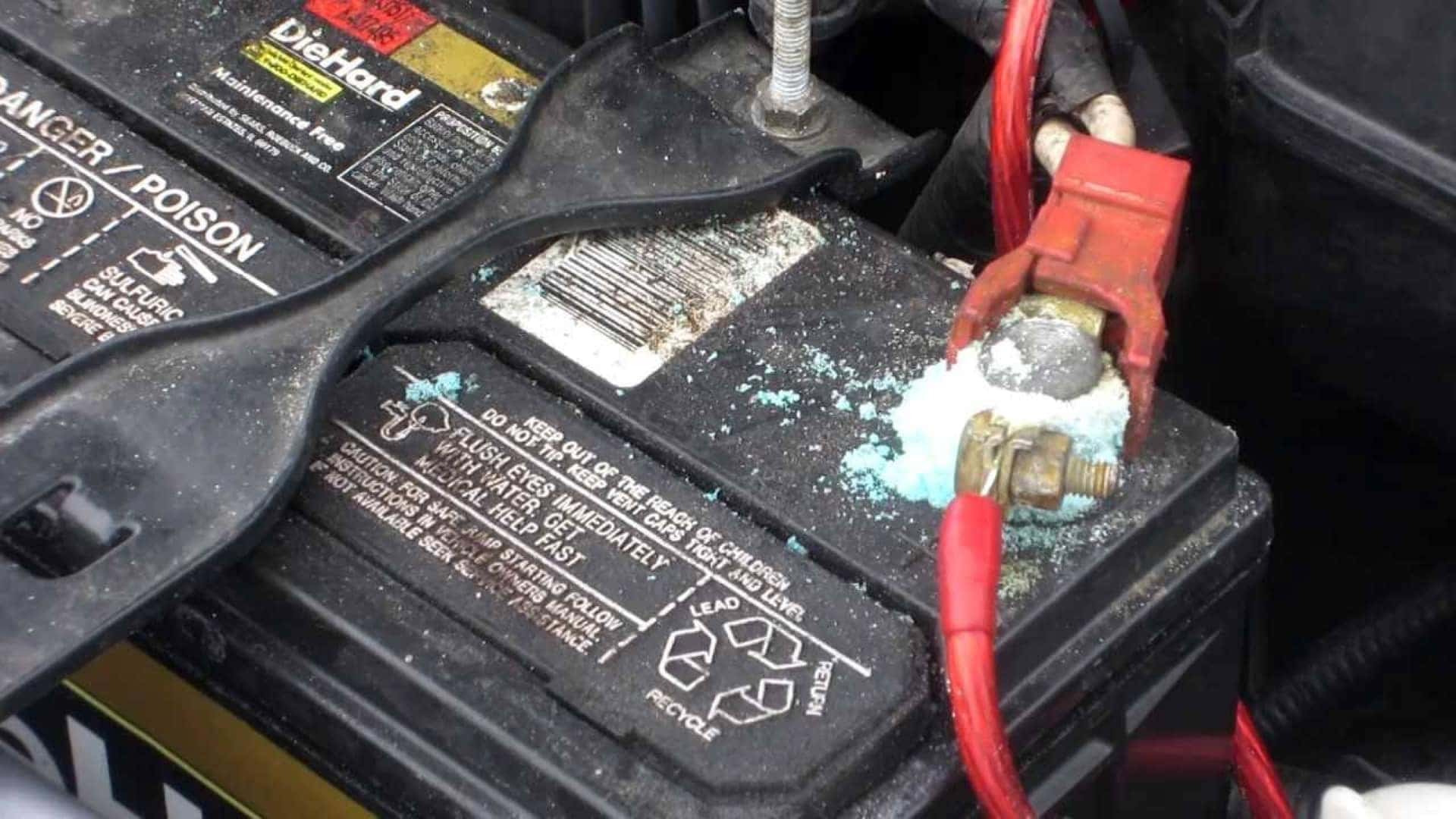 A Corroded Battery With Jumper Cables Attached To Them