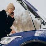 A Woman Stranded On The Side Of The Road After Her Car Battery Died And Calling For Help In The Winter Season