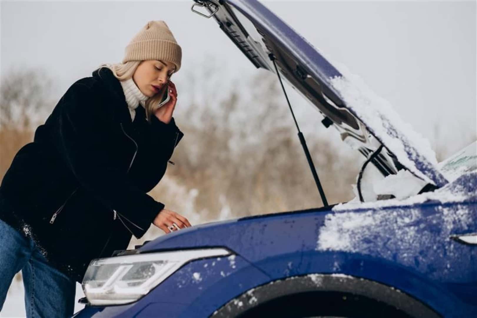 A Woman Stranded On The Side Of The Road After Her Car Battery Died And Calling For Help In The Winter Season