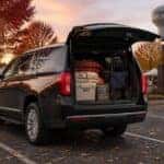 2022 GMC Yukon XL Denali with rear cargo open and fall festival gear loaded at dusk in Fishers, Indiana
