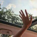 Person Touching Clear Glass Vehicle Sun Roof