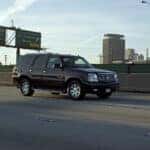 Black suv driving on a highway