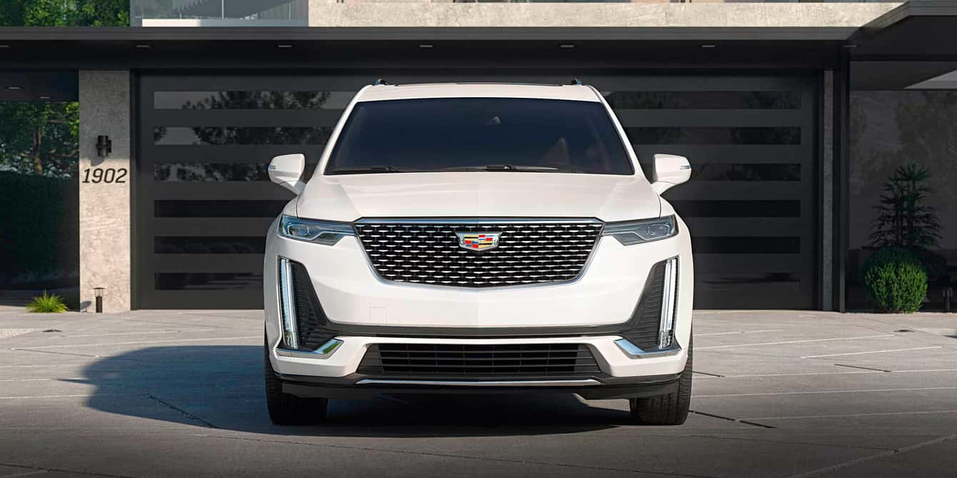 White Cadillac XT6 parked in a driveway