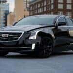 Black Cadillac sedan parked in a parking lot