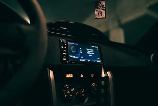 A dashboard of a car with a digital screen