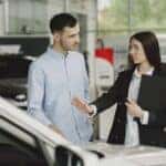 Woman Selling Car to Client in Salon