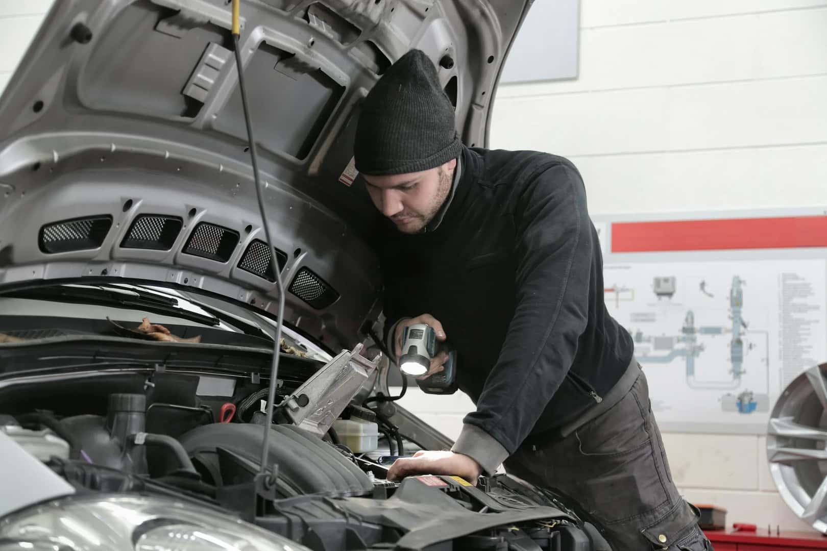 Man inspecting car engine