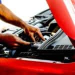 person fixing car during daytime