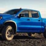 2025 Chevrolet Silverado 1500 parked on a gravel road on a hill