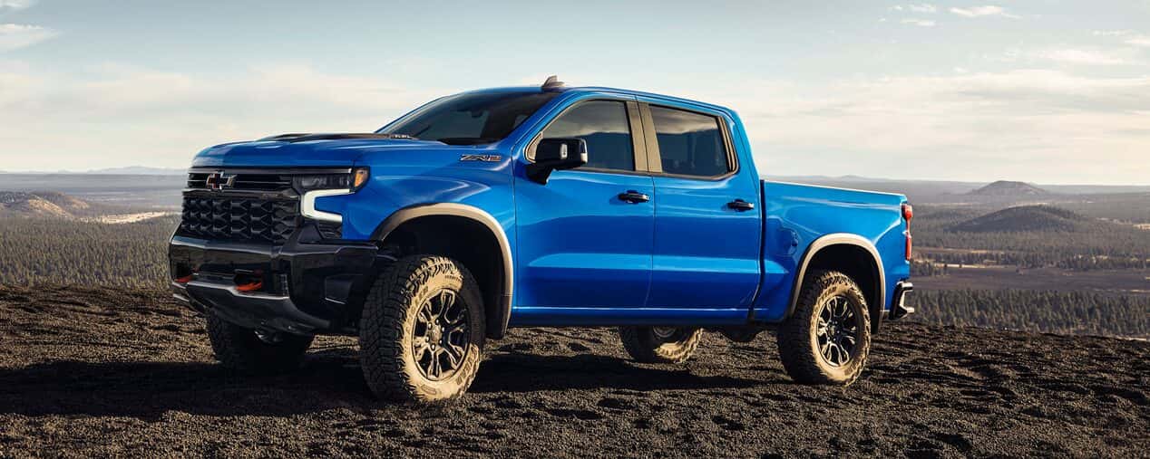 Chevrolet Silverado 1500 parked on a gravel road on a hill