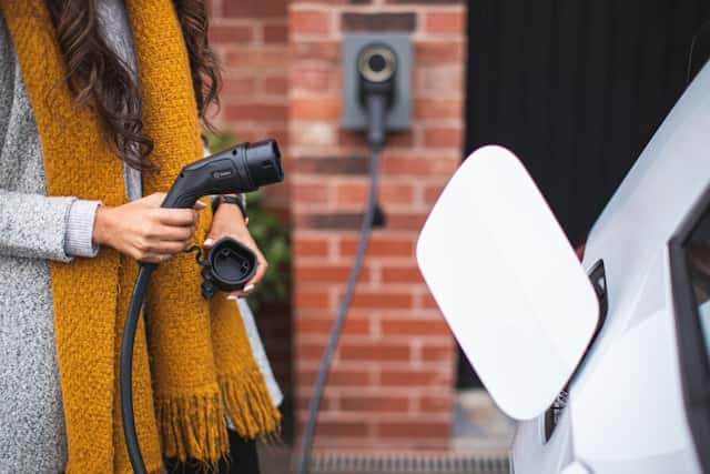 A woman charging an EV