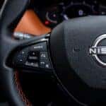 Close-up of a nissan steering wheel with controls
