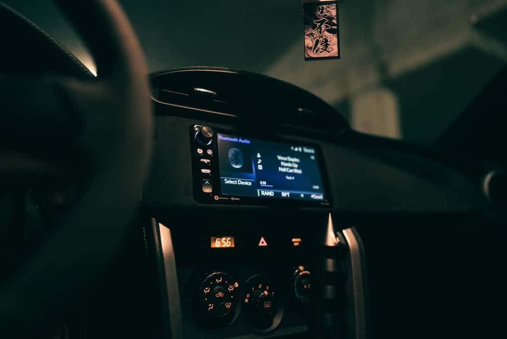 A dashboard of a car with a digital screen