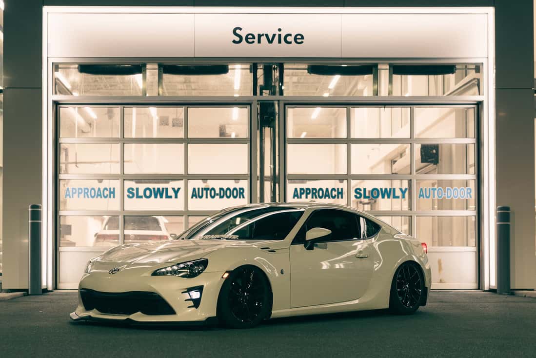 A white car parked in front of a building