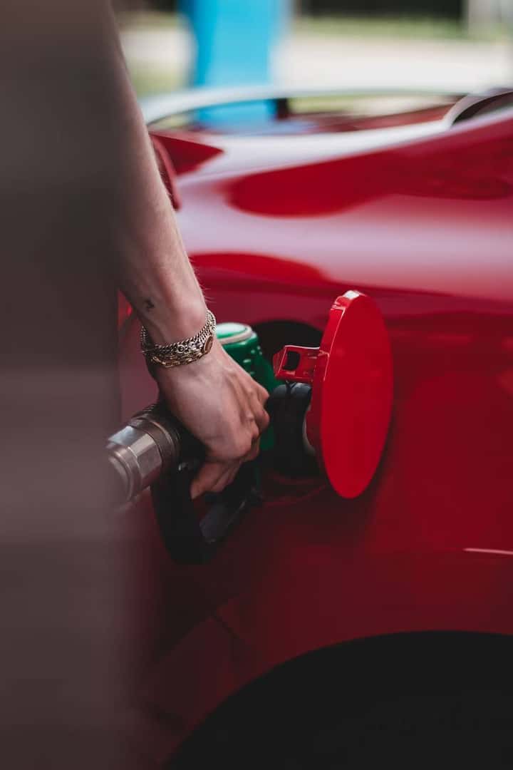 Person filling up a car's gas tank