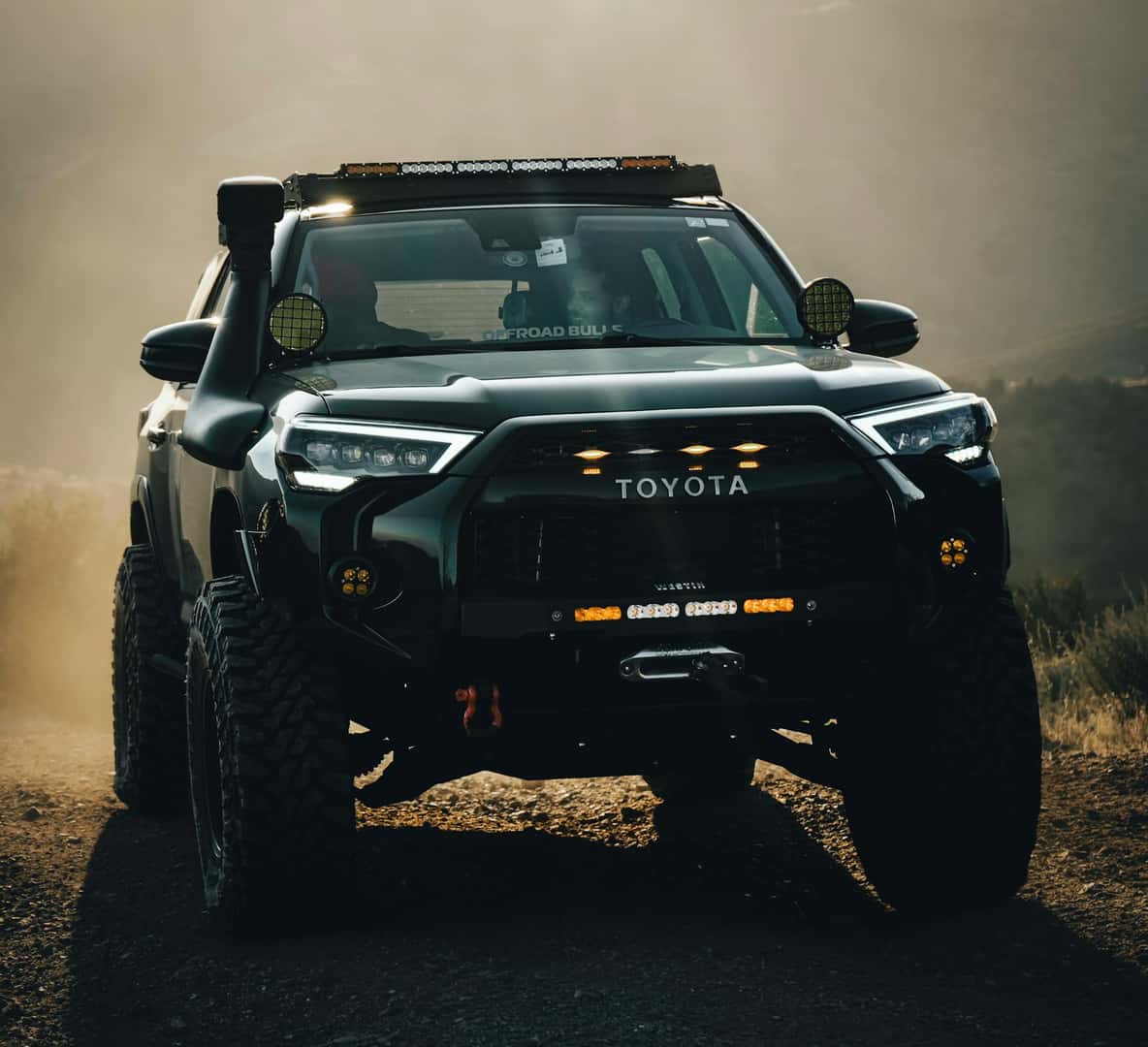 Off-Road Toyota Truck in Dusty Landscape