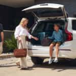 A family packing the back of their white Volvo XC90.