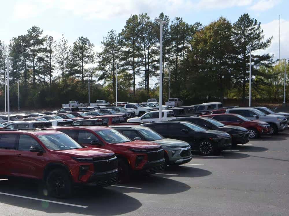 A red and silver Chevrolet SUV facing eachother outside on a road near hills