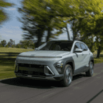 2025 Hyundai Kona cruising through a tree-lined road, highlighting its advanced driver-assist features perfect for Athens roads.