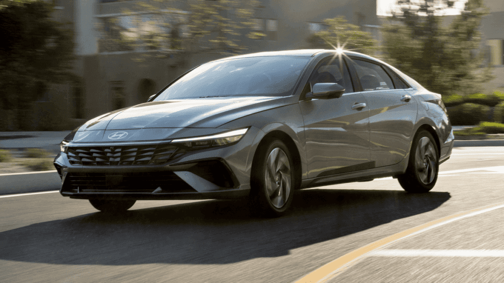 2025 Hyundai Elantra driving through city streets, built for daily commuting with smart features for Athens, GA professionals.