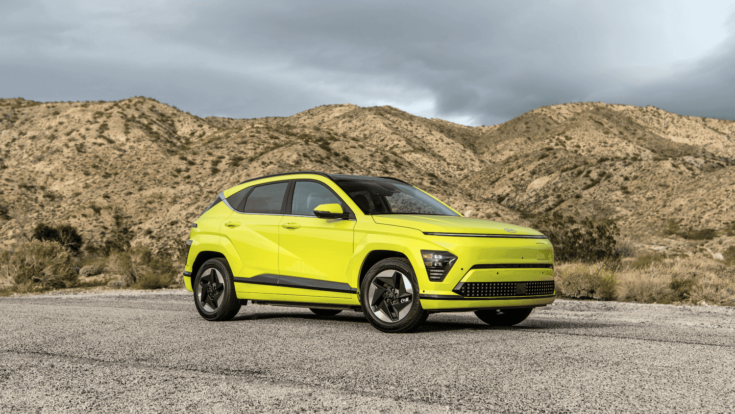 Bright green 2025 Hyundai Kona Electric parked in the Athens, GA countryside, showcasing its eco-friendly design and urban versatility.