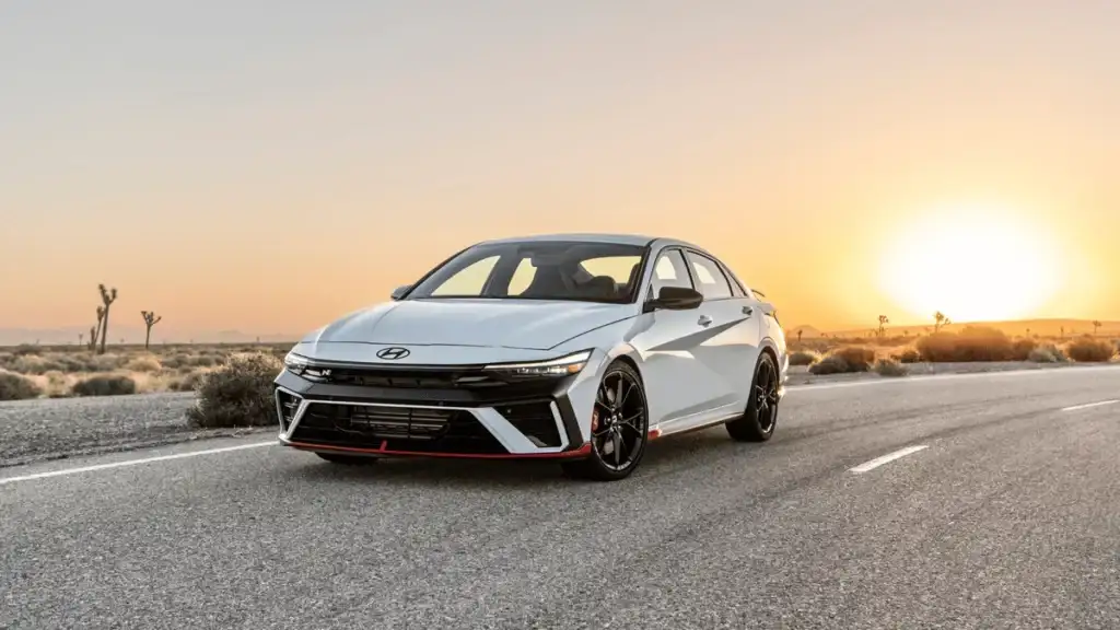 2025 Hyundai Elantra N parked on an open desert road at sunset, showcasing its sporty design and performance-focused styling.