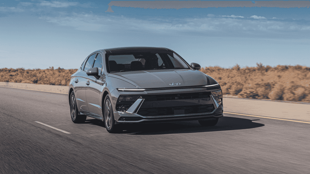 2025 Hyundai Sonata Hybrid driving down the highway near Athens, GA with a sleek and efficient profile