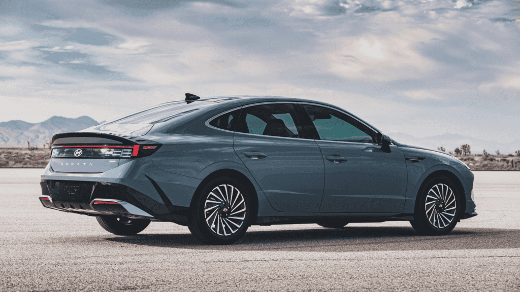 2025 Hyundai Sonata Hybrid driving down the highway near Athens, GA with a sleek and efficient profile