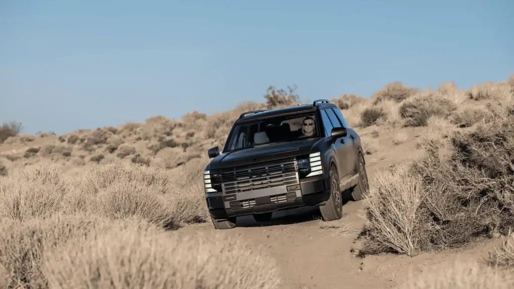 2026 Hyundai Palisade navigating an off-road desert trail, emphasizing rugged durability and family SUV capability.