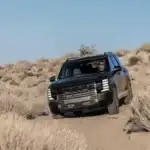 2026 Hyundai Palisade navigating an off-road desert trail, emphasizing rugged durability and family SUV capability.