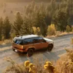 Rear view of the 2025 Hyundai Santa Fe Hybrid driving through a scenic forest trail at sunset, showcasing its rugged design and off-road capability near Athens, GA.